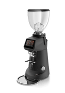 A professional electric coffee grinder with a matte black body, a clear hopper, a digital touch screen display, and a chrome drip tray, shown on a solid white background.