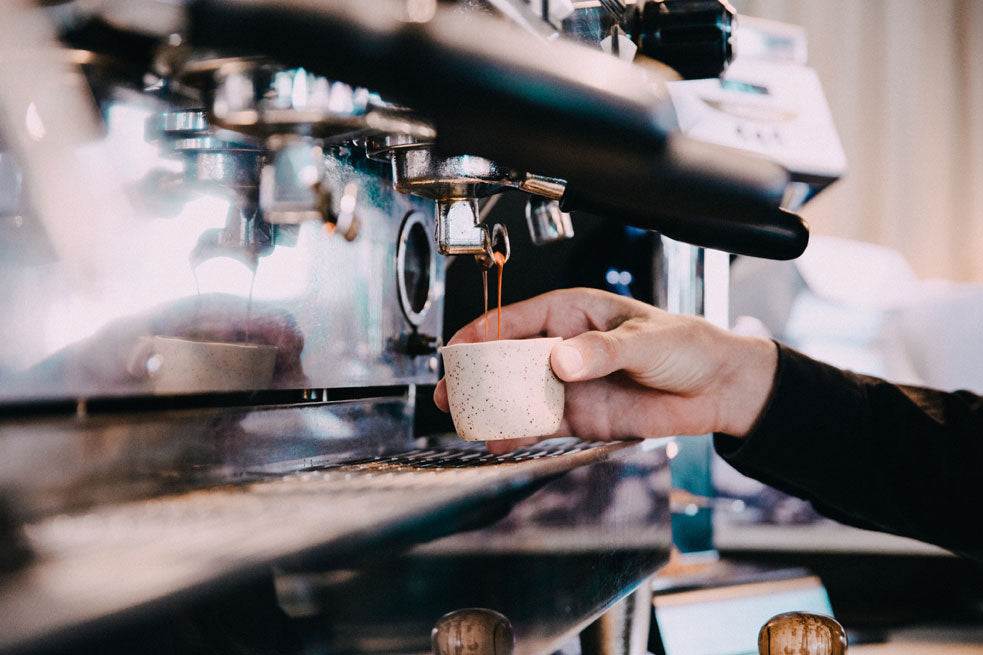 barista making a double shot of espresso