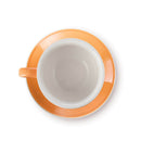 Overhead shot of orange cappuccino cup on matching saucer