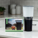 Toddy Essential Brewer cold brew coffee maker on countertop next to retail box with iced coffee