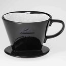 Kalita 102 black ceramic dripper with white paper filter ready for brewing