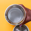 Overhead view of polished stainless steel interior in white Fellow Carter Wide mug