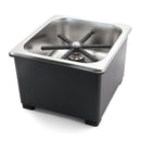 Black six-pronged spray arm mounted on metal riser in stainless steel basin