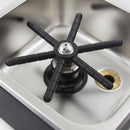Close-up of black six-armed spray nozzle inside stainless steel rinser basin