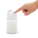 Hand pressing OXO creamer dispenser lever to pour milk