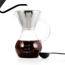 Pour over coffee brewing in Yama glass drip pot with gooseneck kettle and scoop