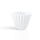 Upright Kalita Wave 185 white paper coffee filter with conical shape and scalloped rim