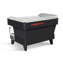 Side rear view of La Marzocco Linea PB commercial espresso machine showing black body and red logo