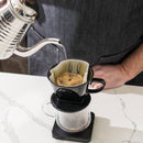 Kalita 102 ceramic dripper on scale with glass carafe and gooseneck kettle