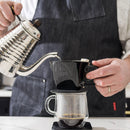 Brewing Kalita Style 102 Ceramic Coffee Dripper in black with gooseneck kettle